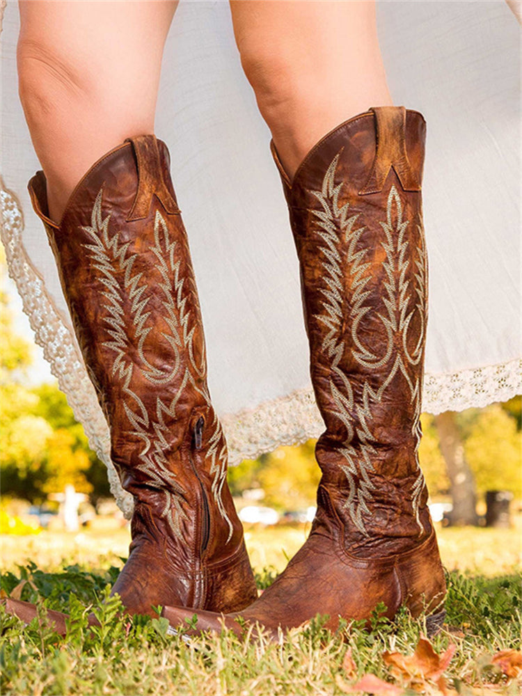 Knee-high western cowboy boots with embroidered botanical detailing and pointed toes