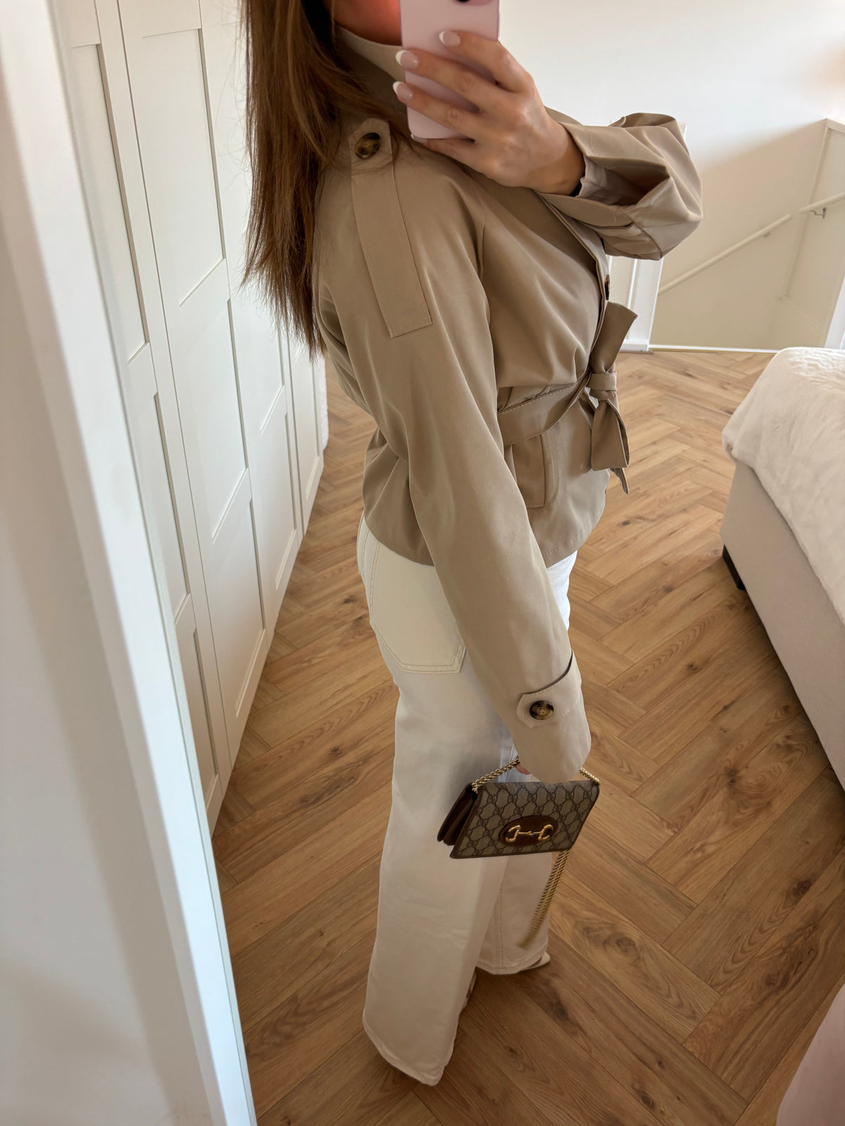 Women's beige belted trench jacket with high collar and long sleeves