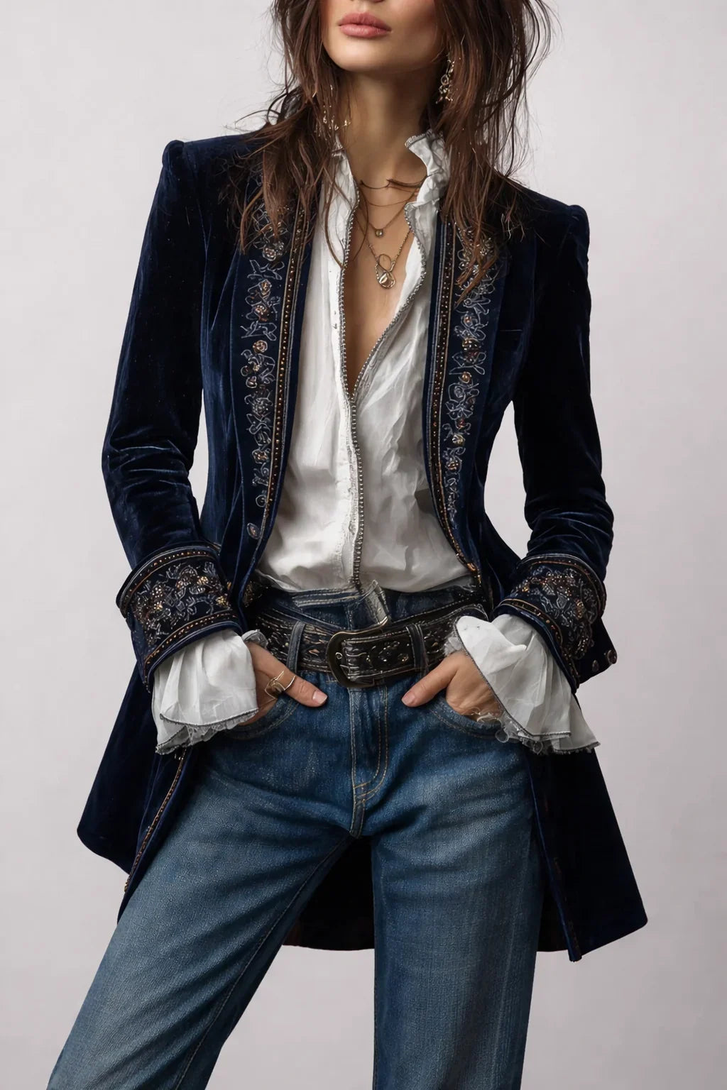 Women's long embroidered velvet jacket with structured shoulders and decorative floral cuffs