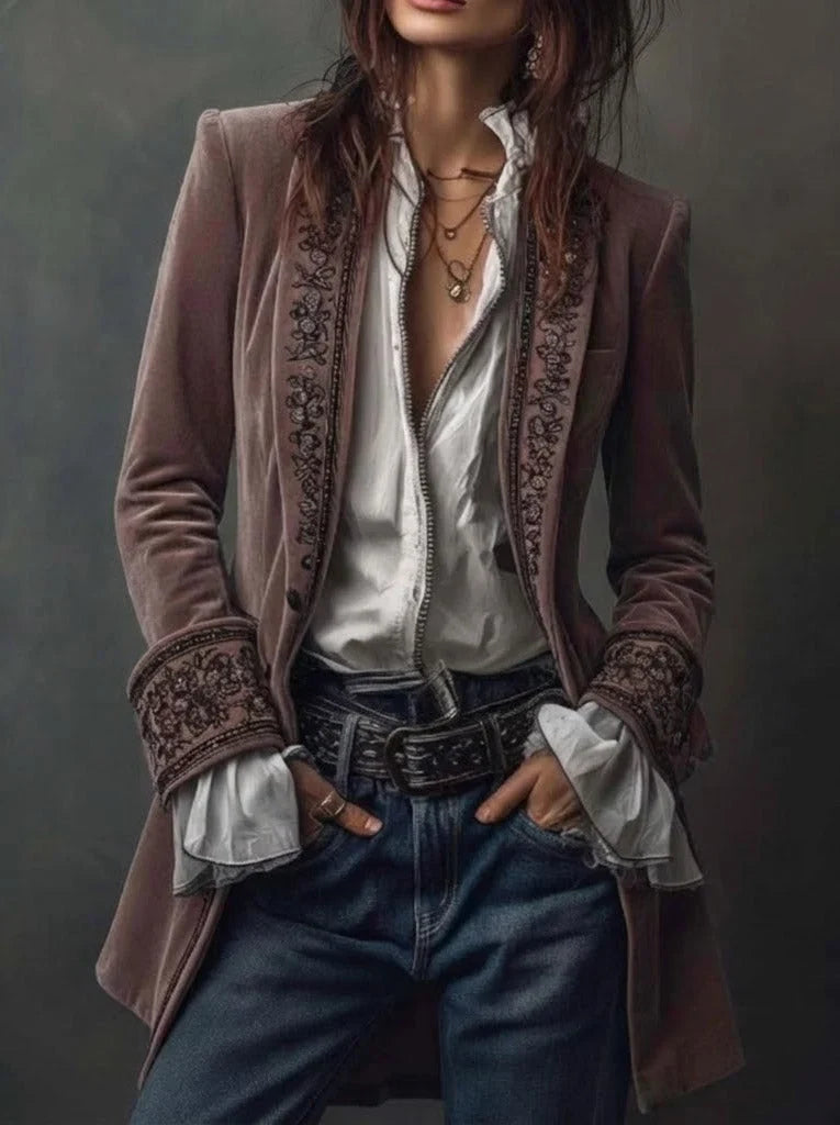 Women's long embroidered velvet jacket with structured shoulders and decorative floral cuffs