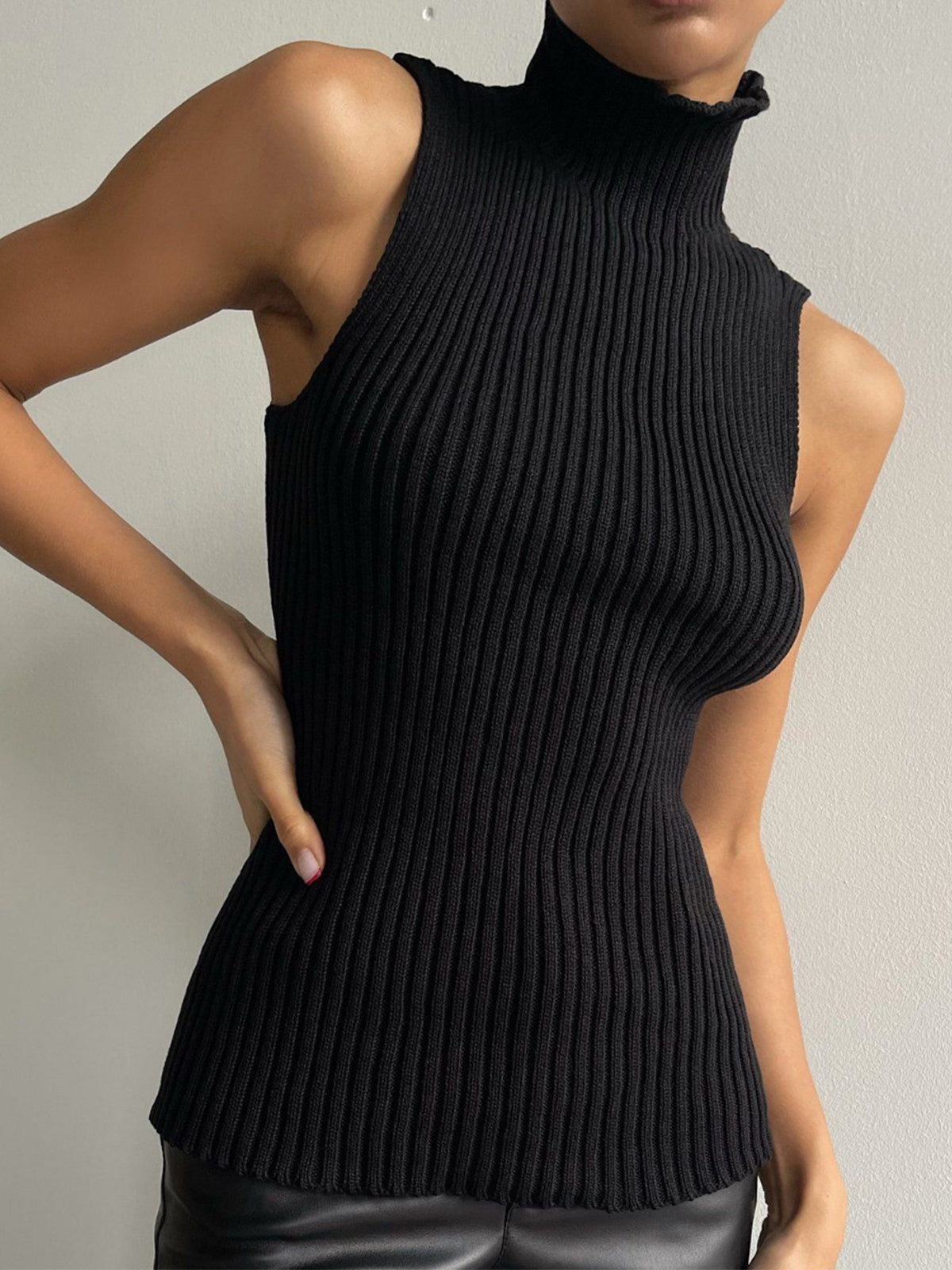Women's ribbed sleeveless knit top with high neckline and fitted shape