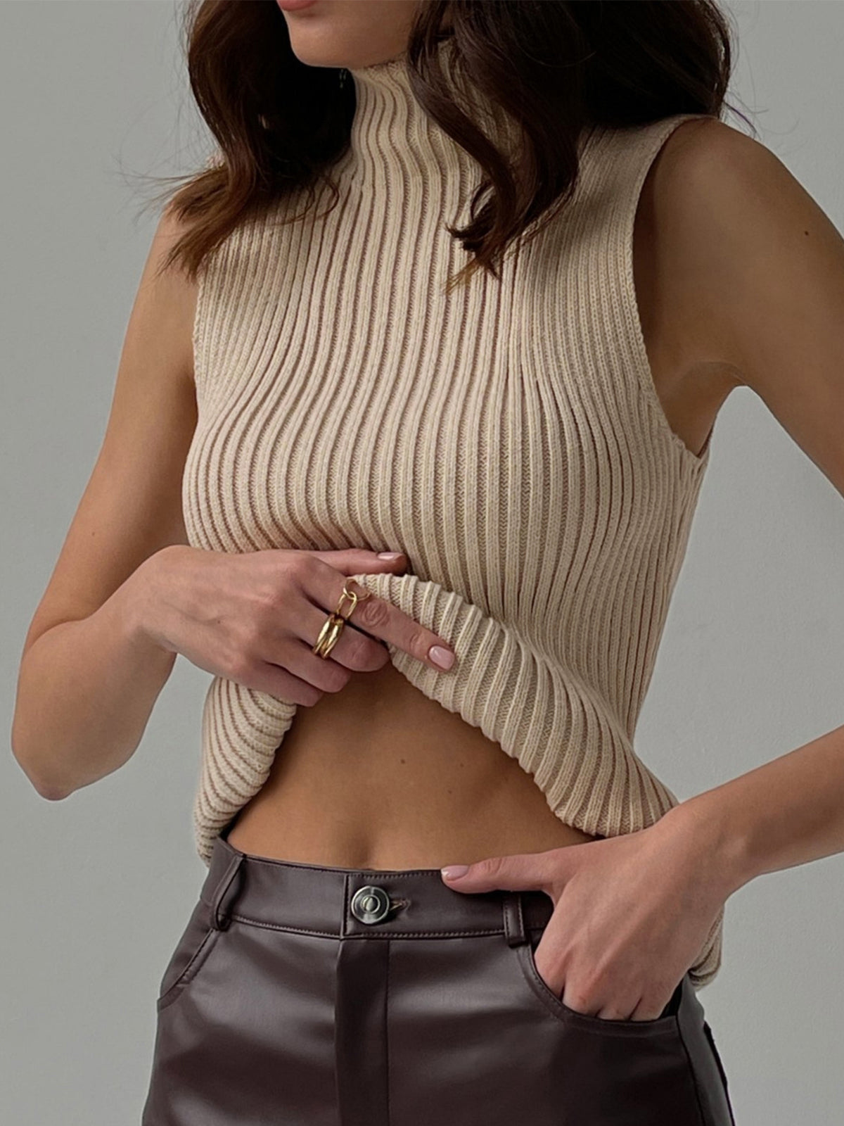 Women's ribbed sleeveless knit top with high neckline and fitted shape