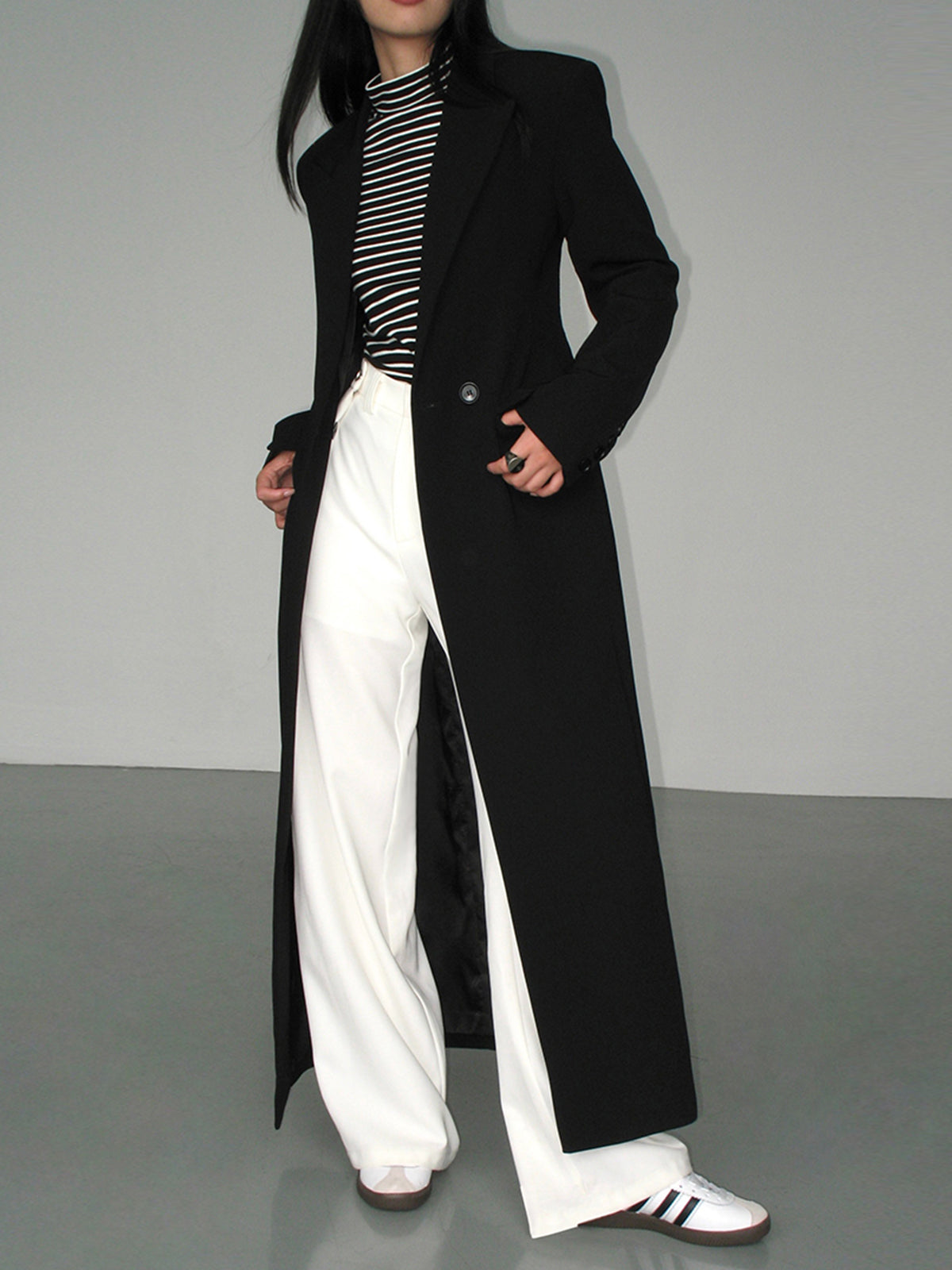 Women's black long tailored coat with lapels and one-button closure