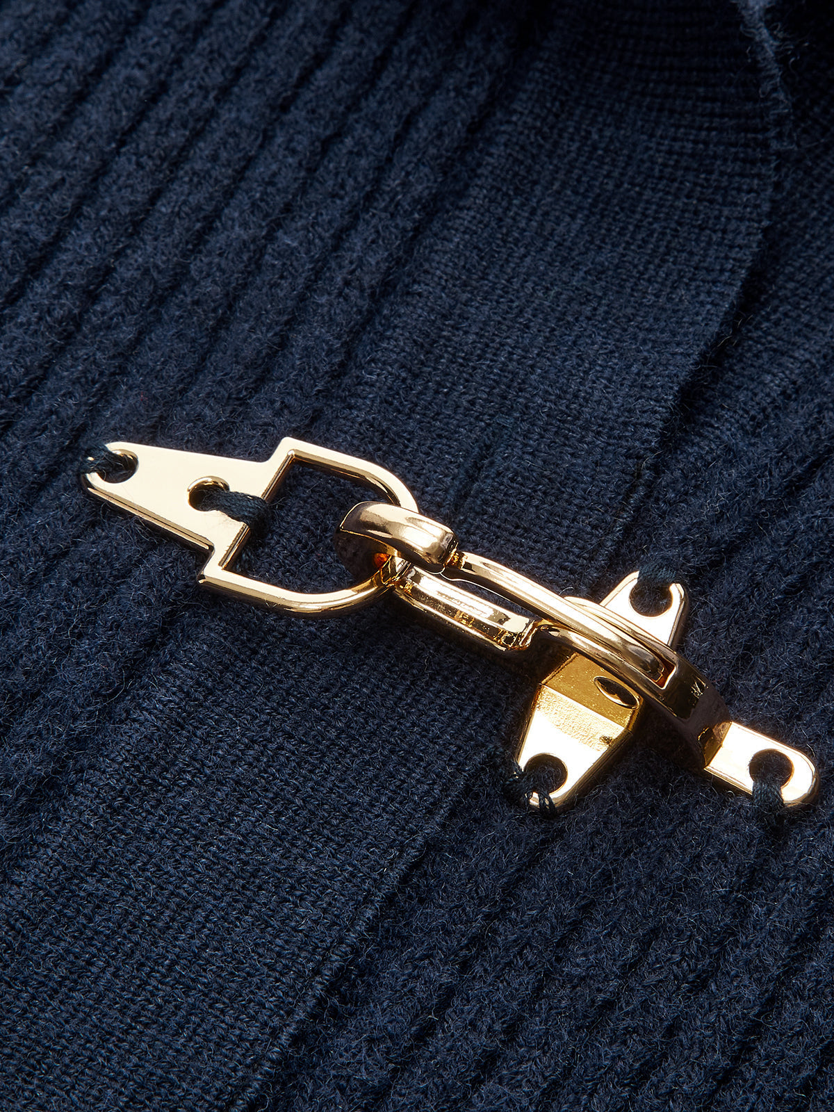 Women's ribbed cropped sweater with collared neckline and metal buckle fastenings