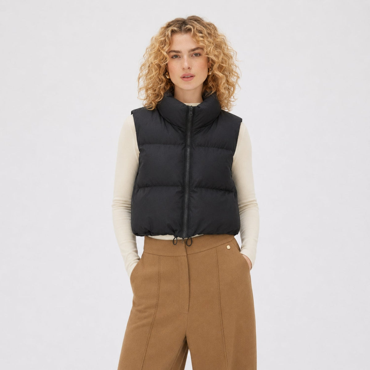 Women's cropped quilted puffer vest with high collar and zip front