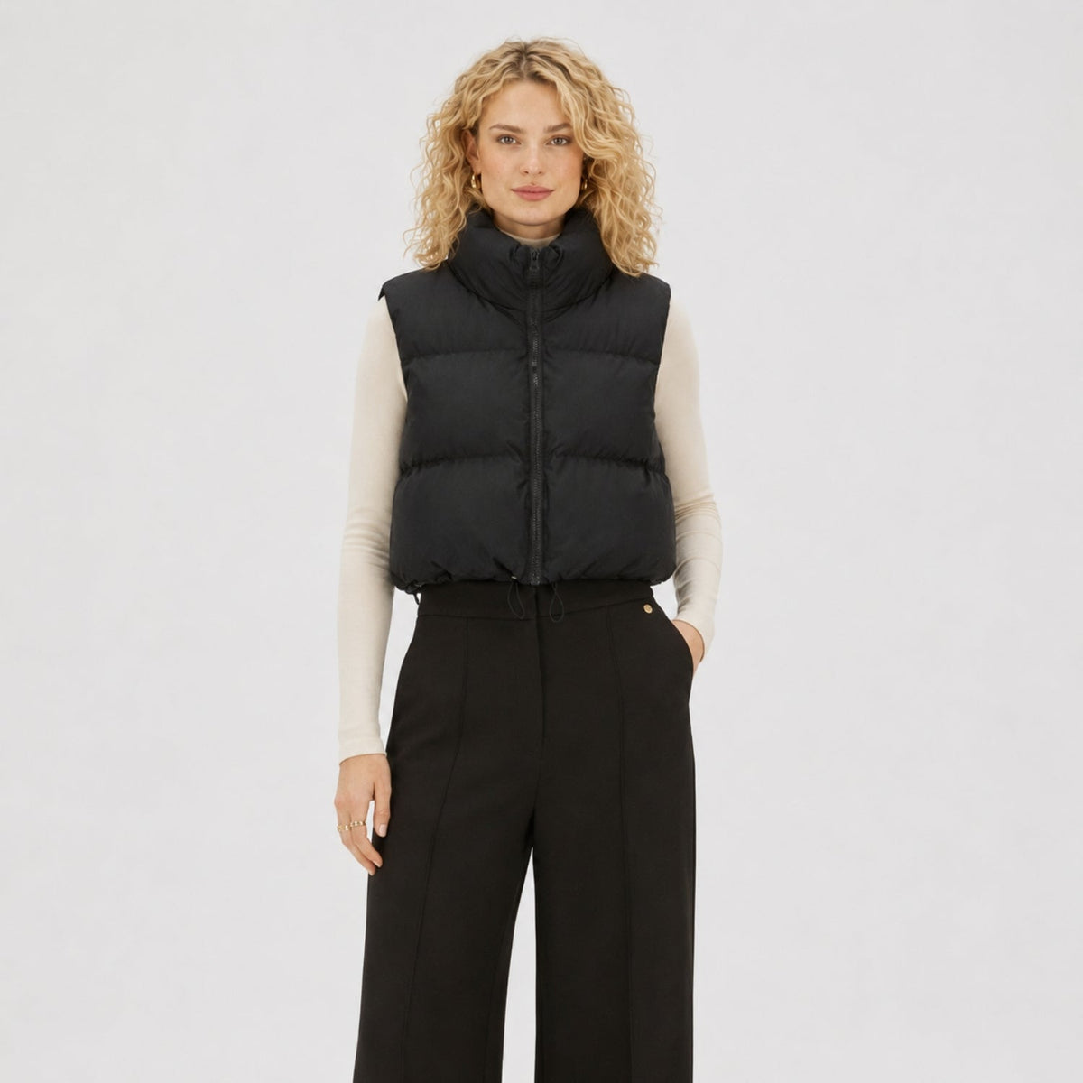 Women's cropped quilted puffer vest with high collar and zip front