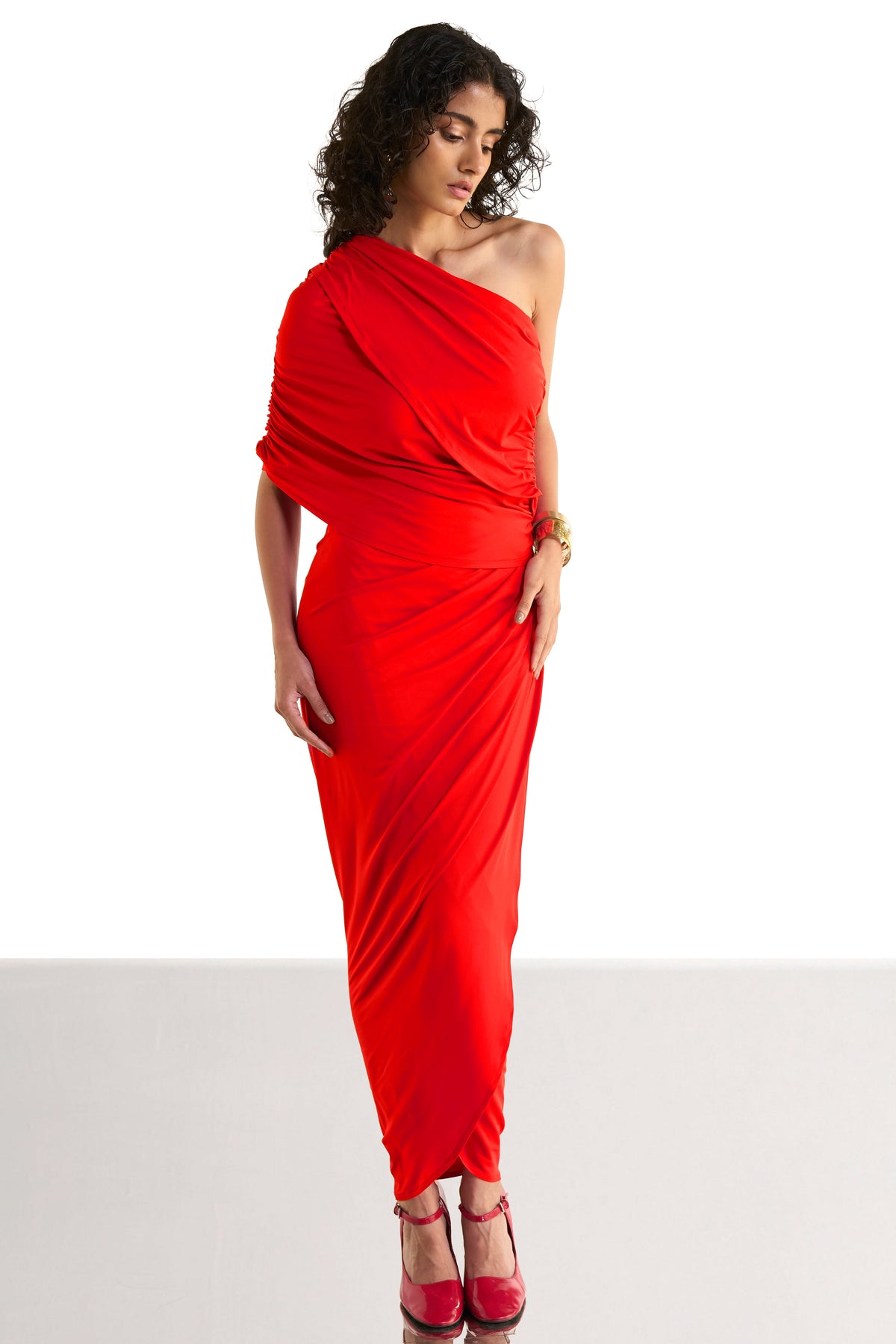 Women's red one-shoulder draped knit top and ruched long skirt co-ord set