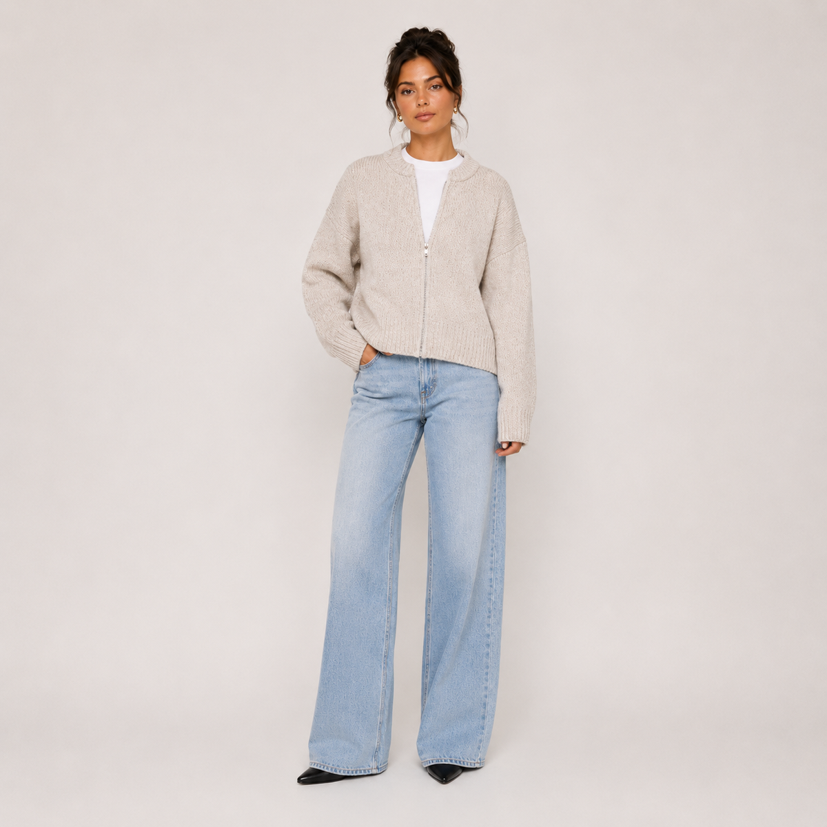 Women's beige knitted jacket with round neckline, zip front and long sleeves