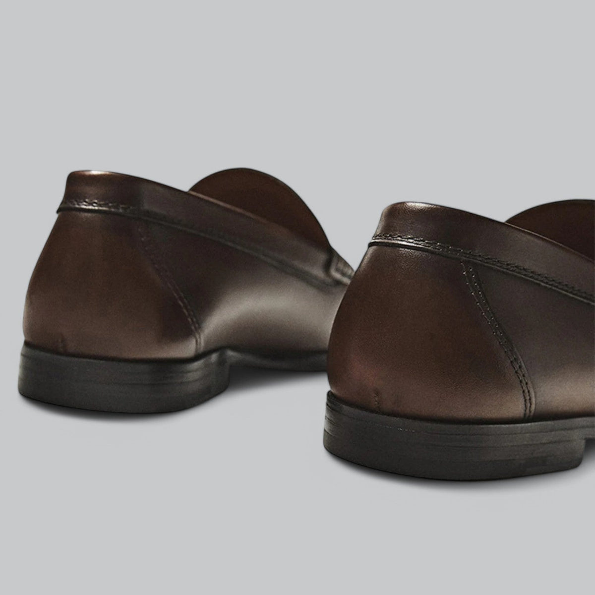 Men's plain penny loafers with stitched trim and low heel