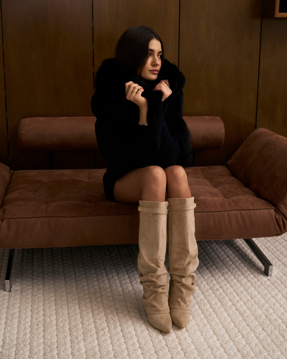 Women's beige slouchy knee-high boots with pointed toes, low heels and buckle strap detail