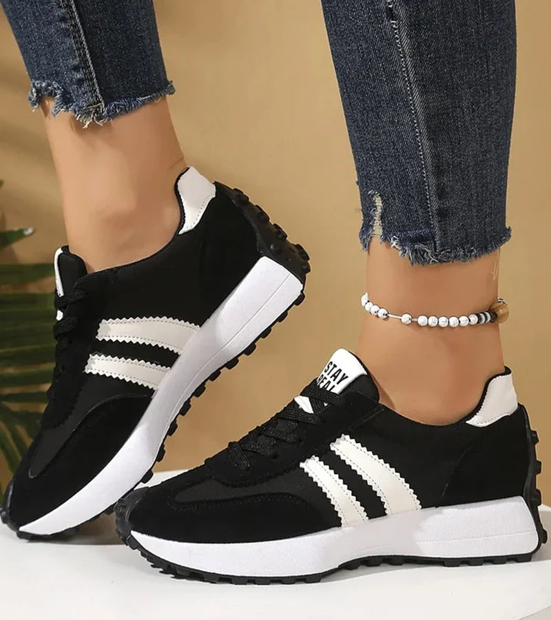 Women's striped lace-up trainers with a round toe and textured flat sole