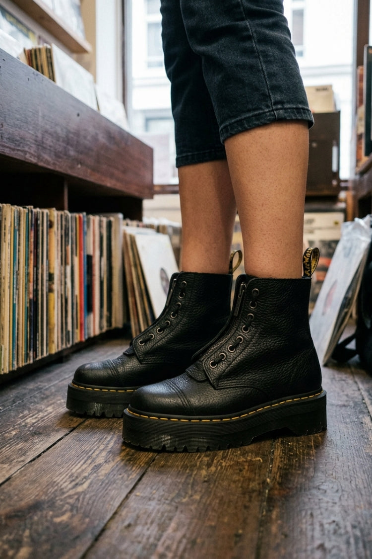 Black women's platform ankle boots with front zip, lace detail and lug soles
