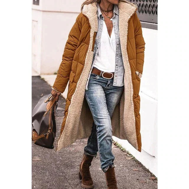 Woman wearing a long hooded quilted puffer coat with contrasting textured trim