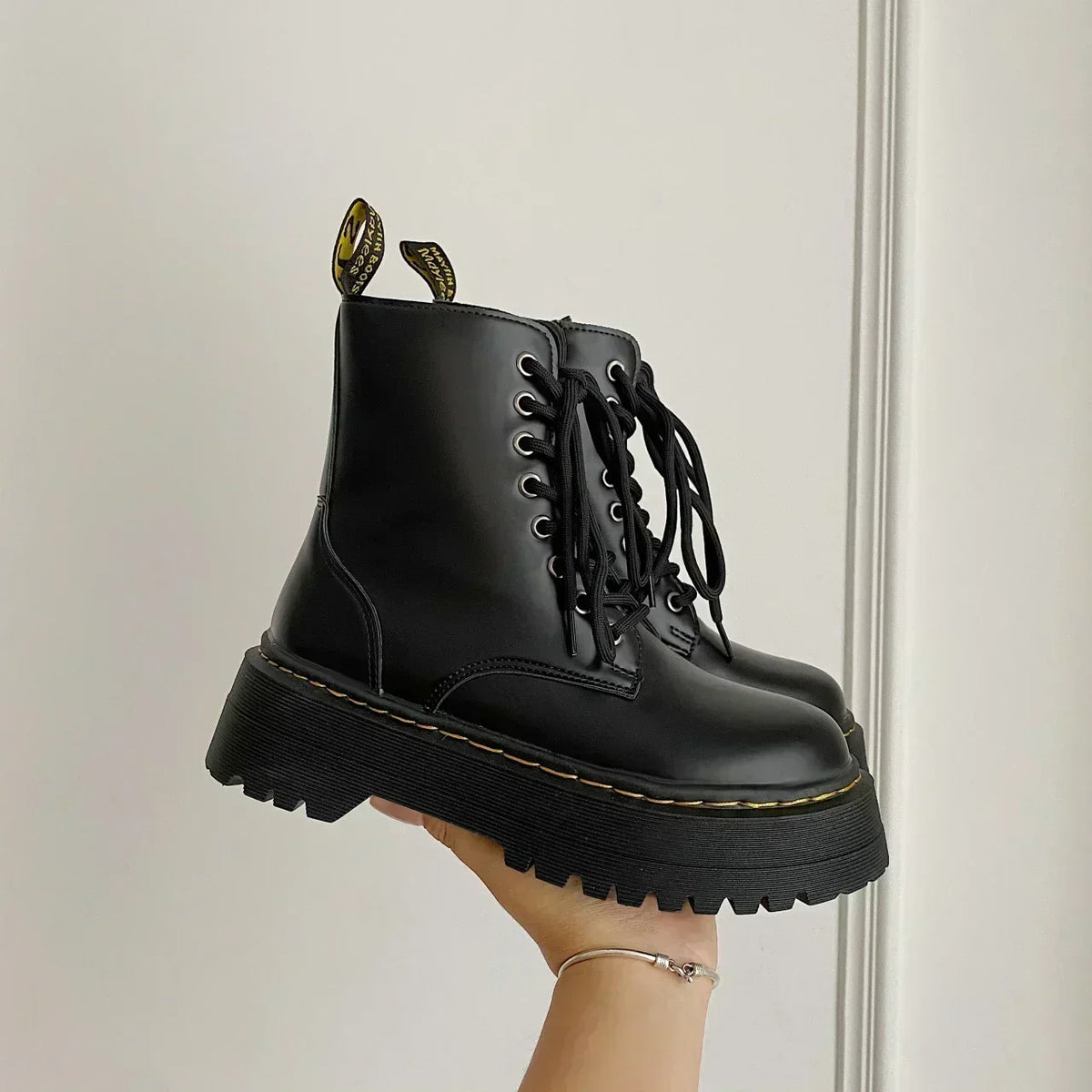Women's black lace-up combat ankle boots with platform soles