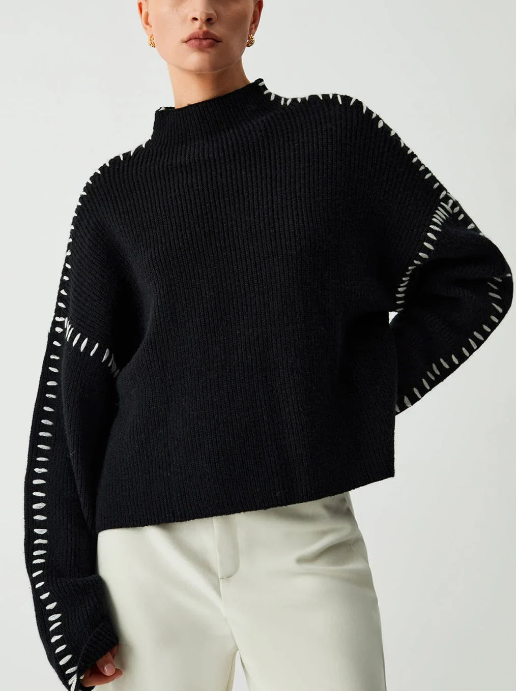 Women's ribbed knit sweater with contrasting stitch trim and long sleeves