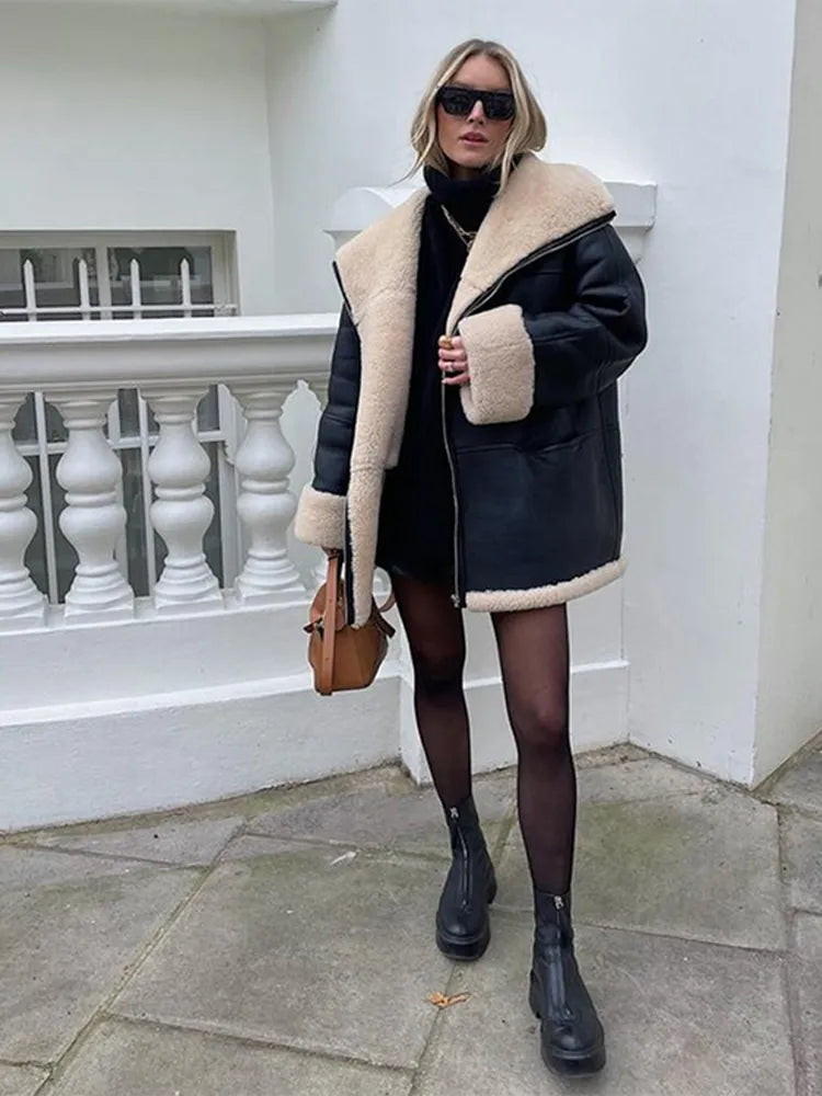 Women's black oversized jacket with cream shearling-style trim and zip front