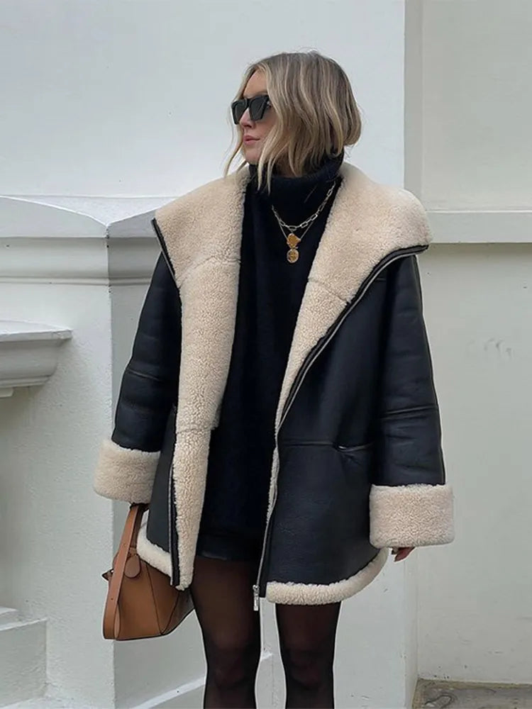Women's black oversized jacket with cream shearling-style trim and zip front