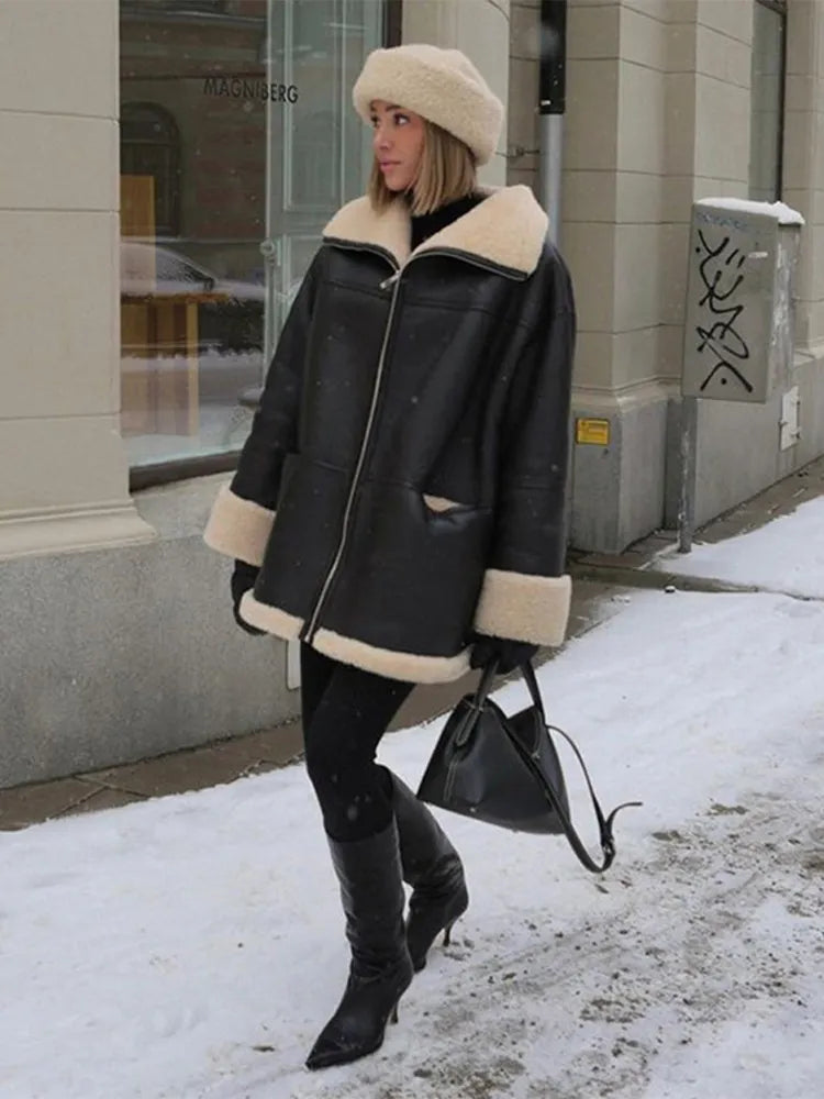 Women's black oversized jacket with cream shearling-style trim and zip front