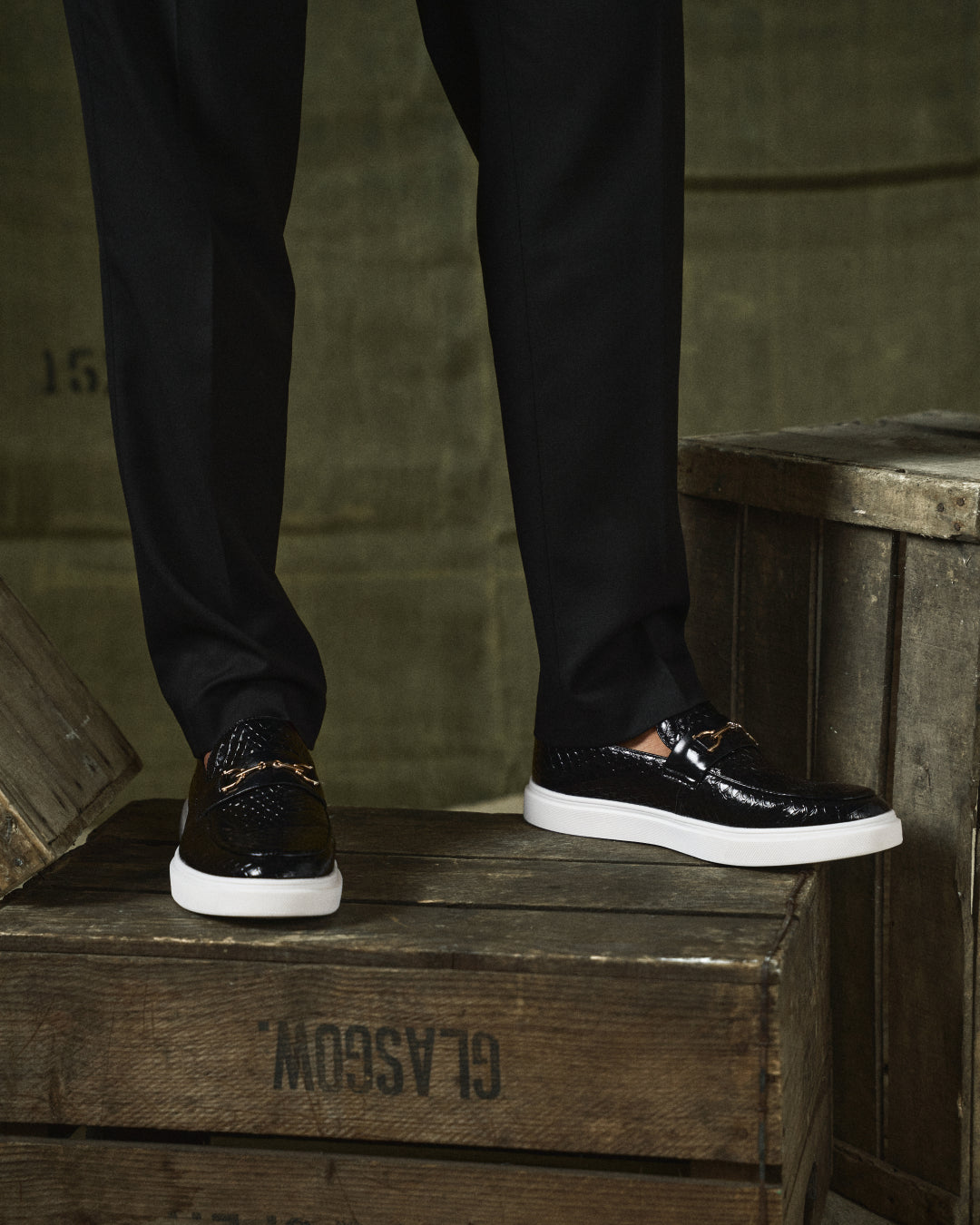 Men's textured slip-on loafers with buckle detail and contrasting flat soles