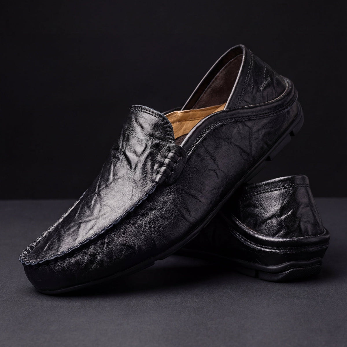 Men's moc toe slip-on loafers with stitched trim and flat soles