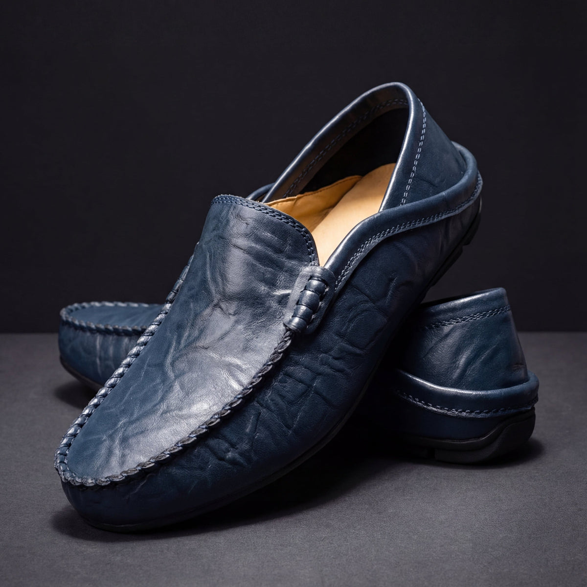 Men's moc toe slip-on loafers with stitched trim and flat soles