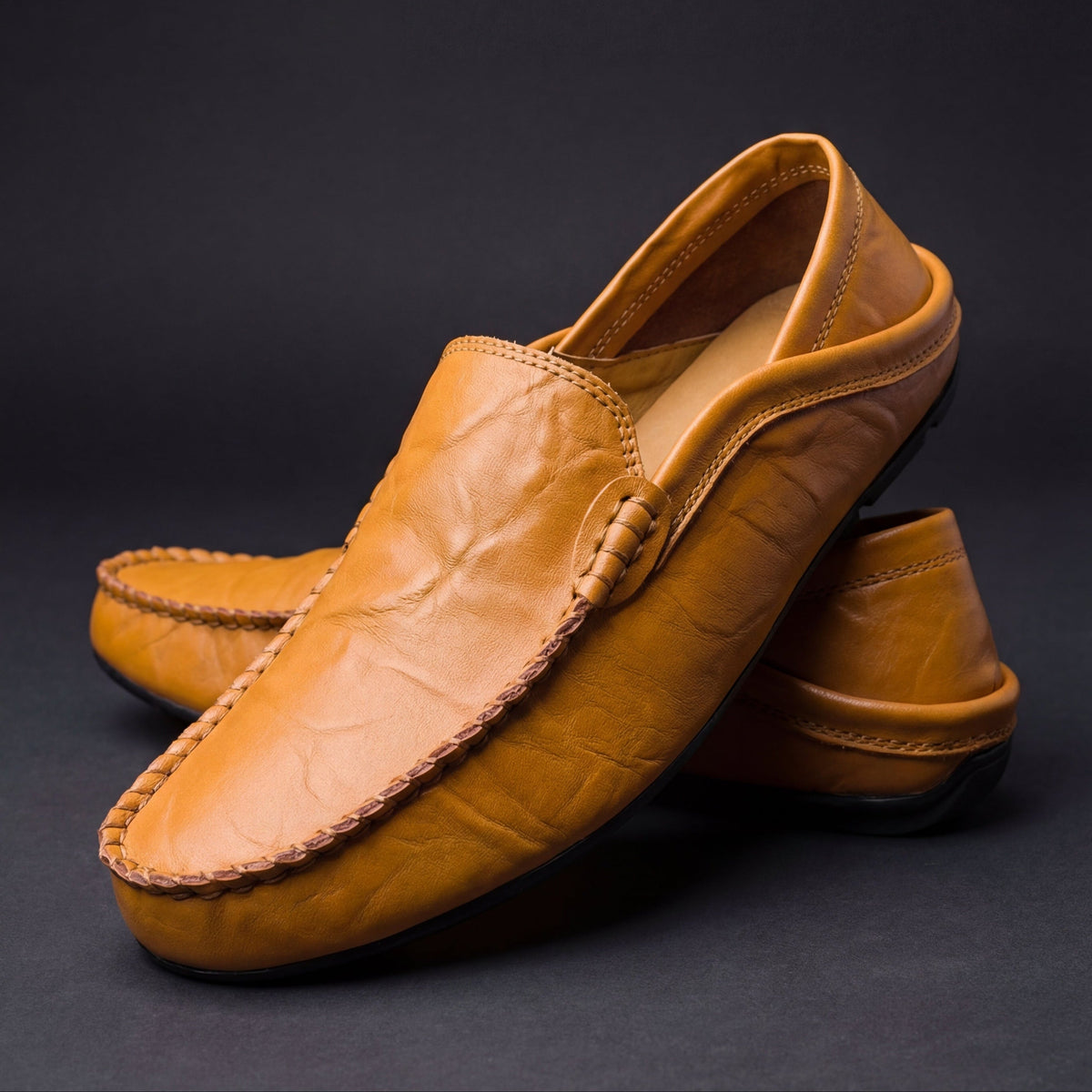 Men's moc toe slip-on loafers with stitched trim and flat soles