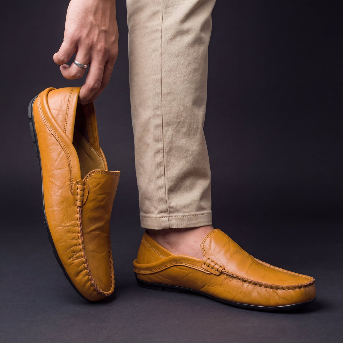 Men's moc toe slip-on loafers with stitched trim and flat soles