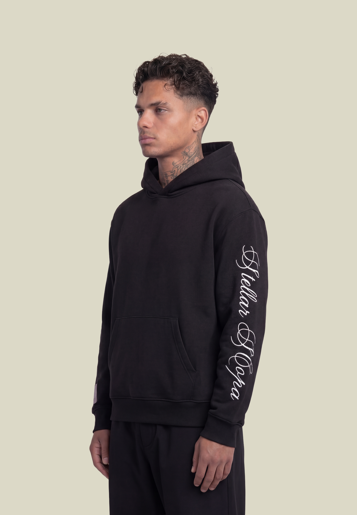 Black hooded sweatshirt with white script sleeve detailing and kangaroo pocket