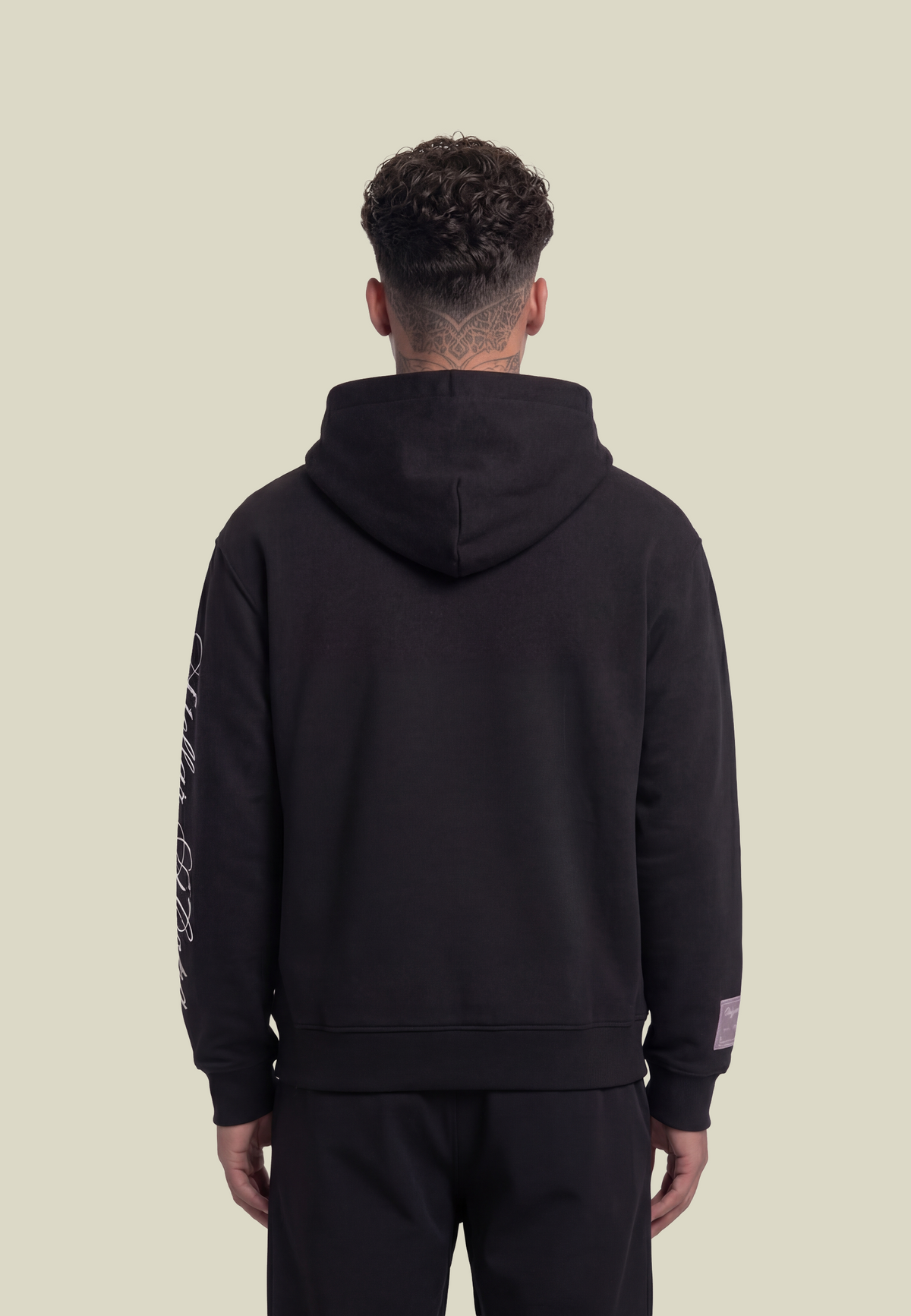 Black hooded sweatshirt with white script sleeve detailing and kangaroo pocket
