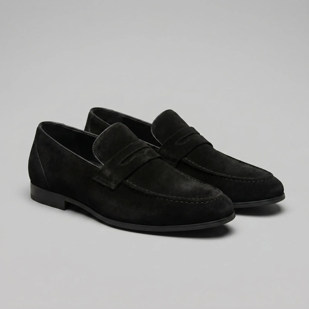 Men's penny loafers with closed backs, raised vamp straps and low flat heels