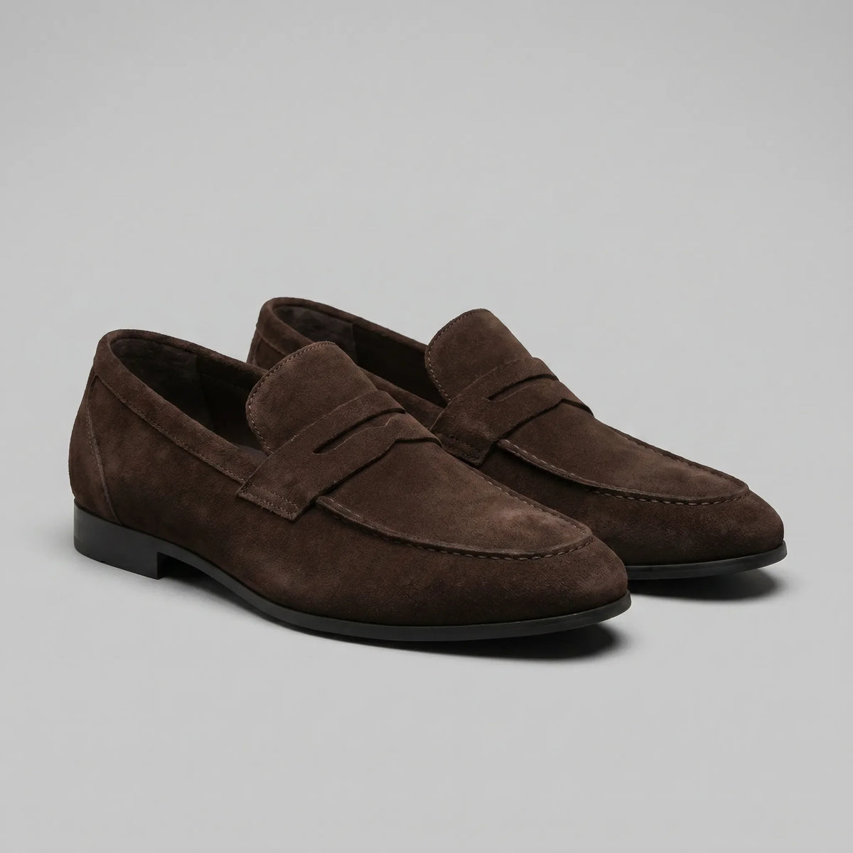 Men's penny loafers with closed backs, raised vamp straps and low flat heels