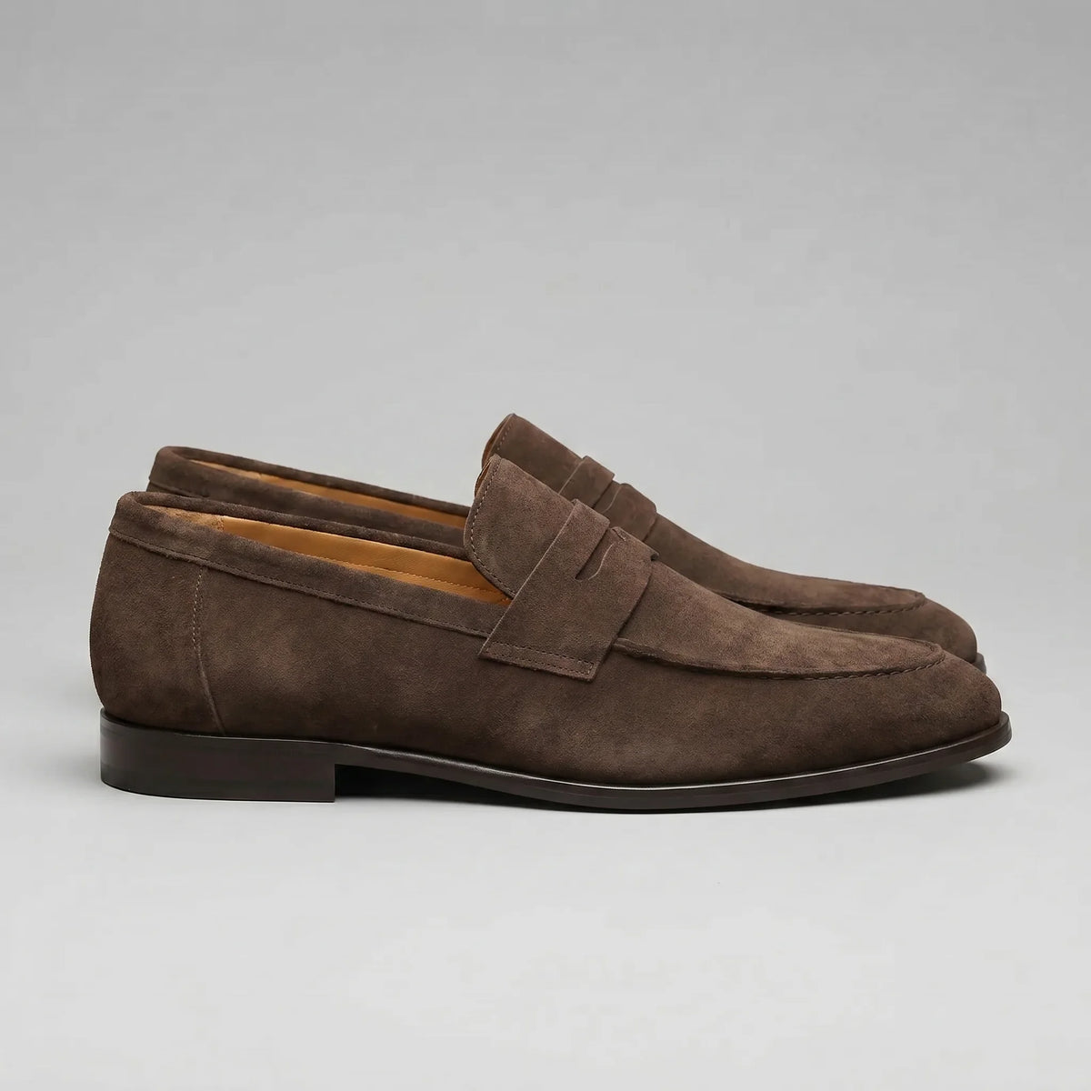 Men's penny loafers with closed backs, raised vamp straps and low flat heels