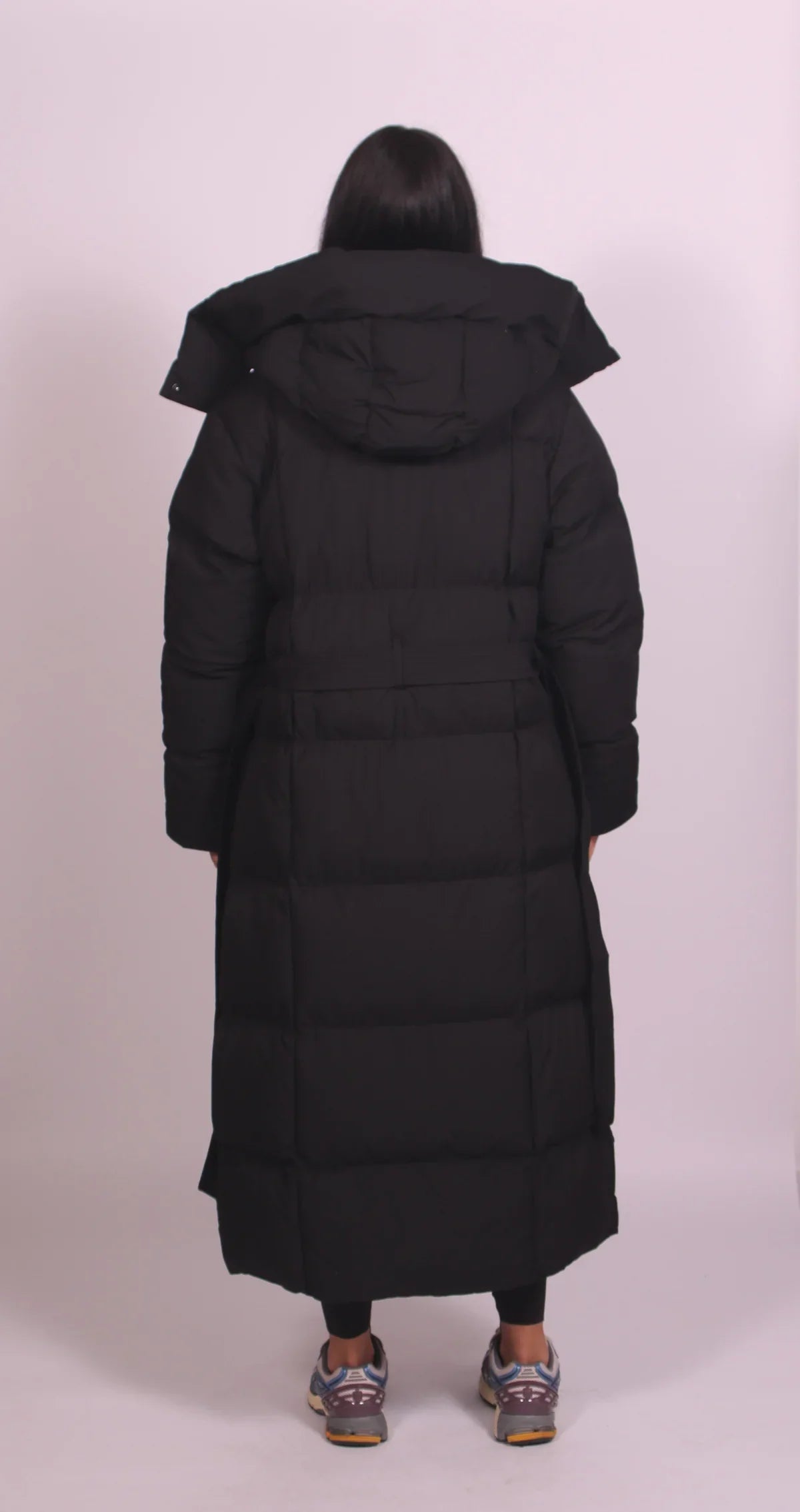 Women's longline hooded puffer coat with a belted waist and front zip