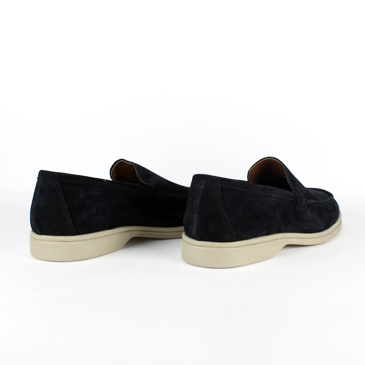 Pair of black men's slip-on loafers with contrasting flat soles