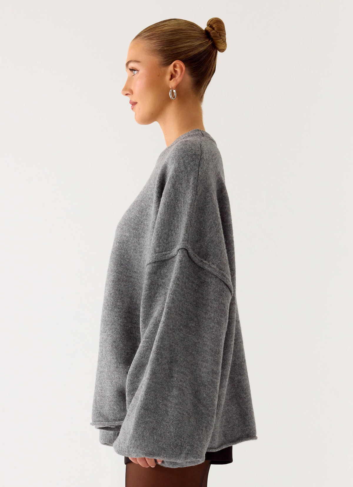 Women's grey oversized knit sweater with crew neck and flared sleeves