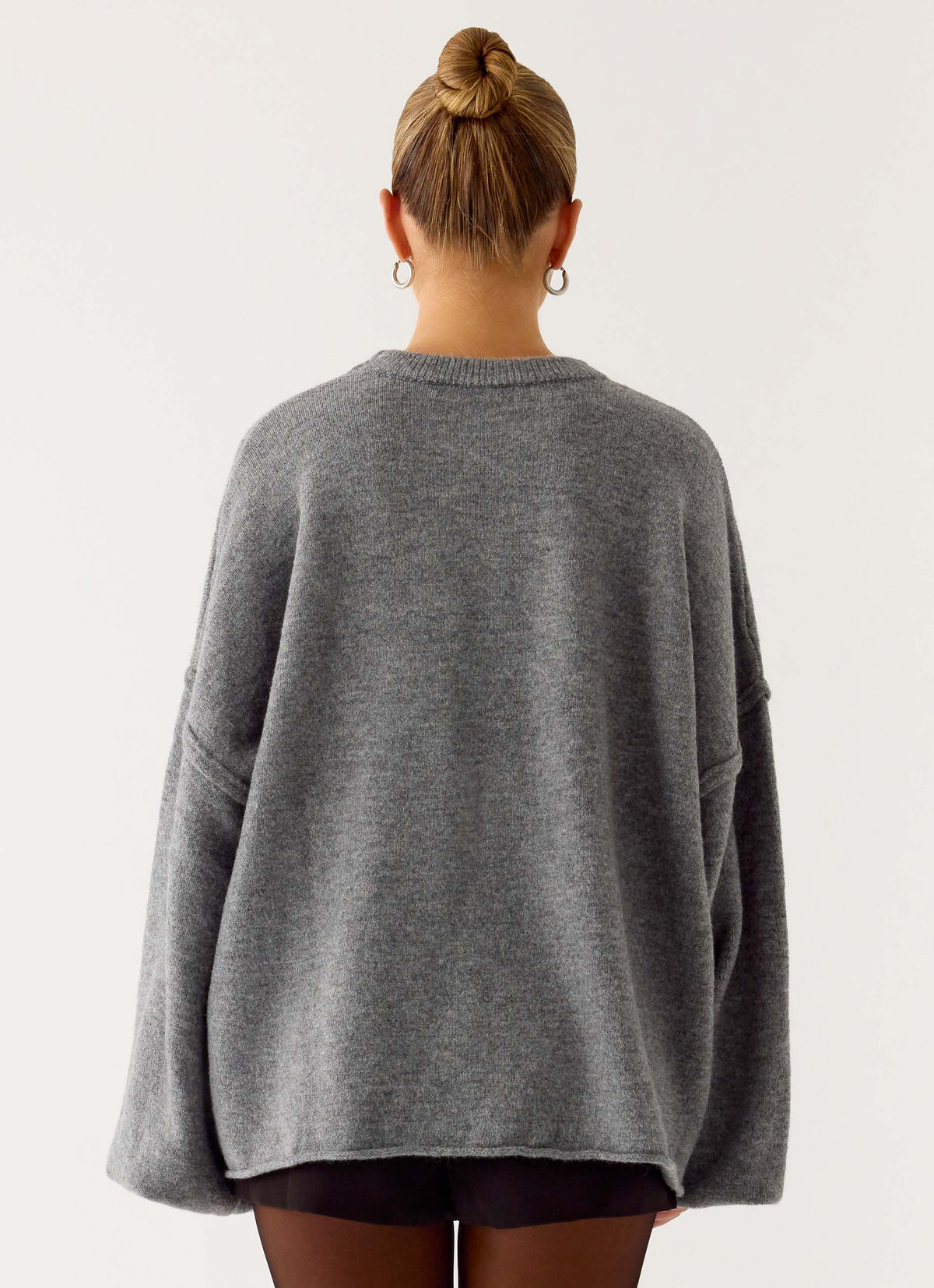 Women's grey oversized knit sweater with crew neck and flared sleeves