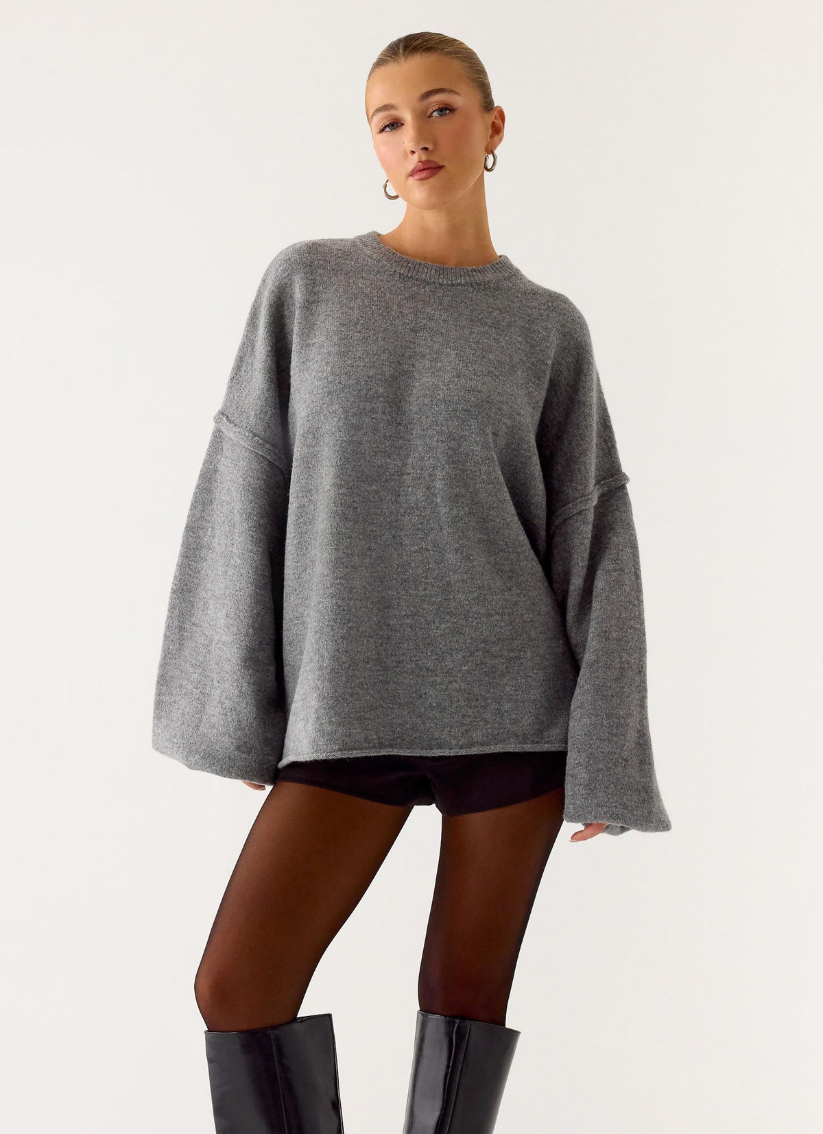 Women's grey oversized knit sweater with crew neck and flared sleeves