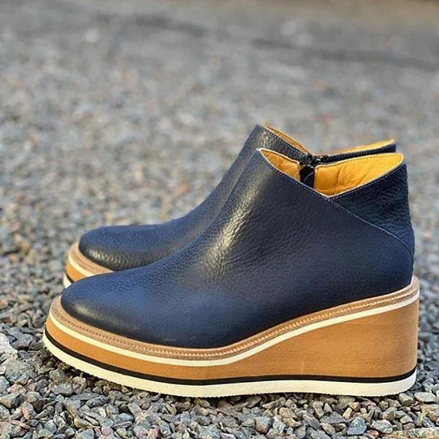 Women's ankle boots with rounded toes, side zips and raised wedge-style soles