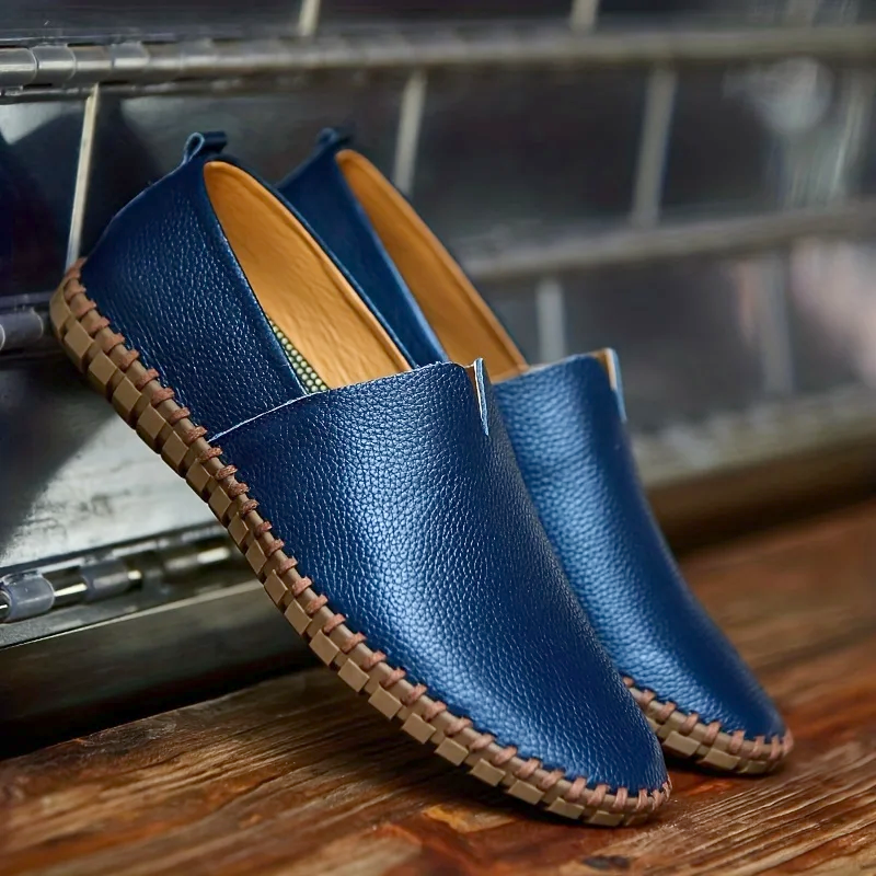 Men's textured slip-on loafer with contrasting stitched trim and flat treaded sole