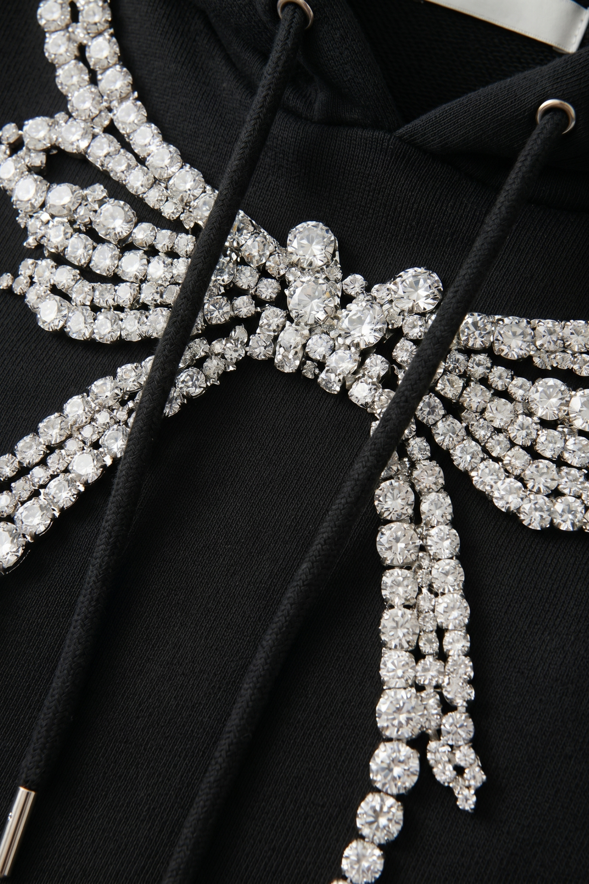 Women's dark hooded hoodie with embellished wing and bow motif, long sleeves and kangaroo pocket
