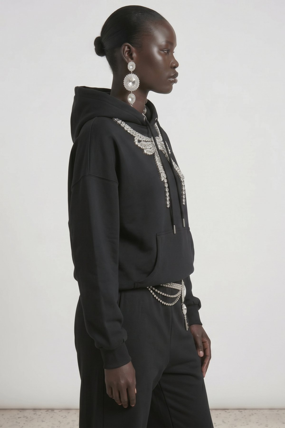 Women's dark hooded hoodie with embellished wing and bow motif, long sleeves and kangaroo pocket