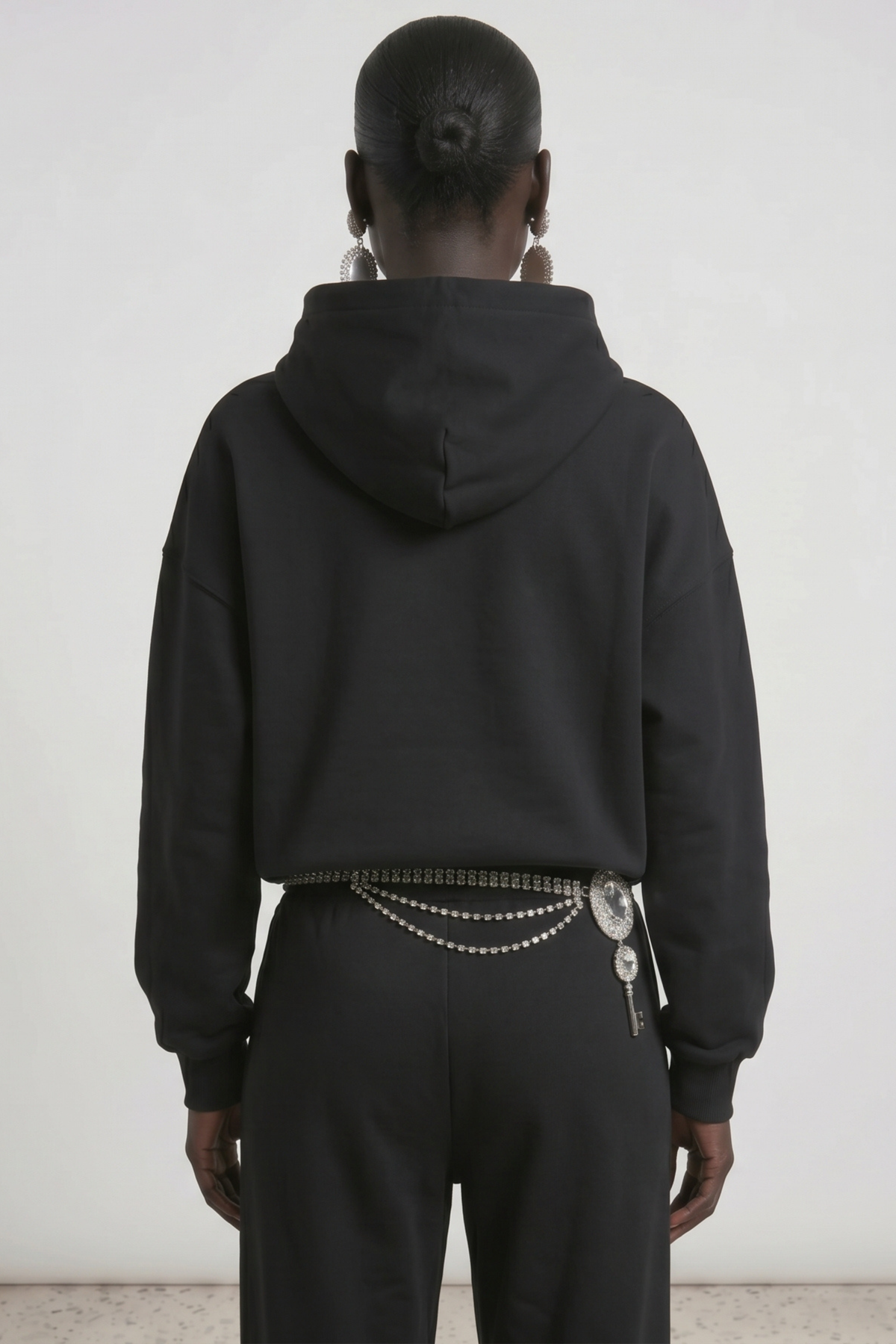 Women's dark hooded hoodie with embellished wing and bow motif, long sleeves and kangaroo pocket