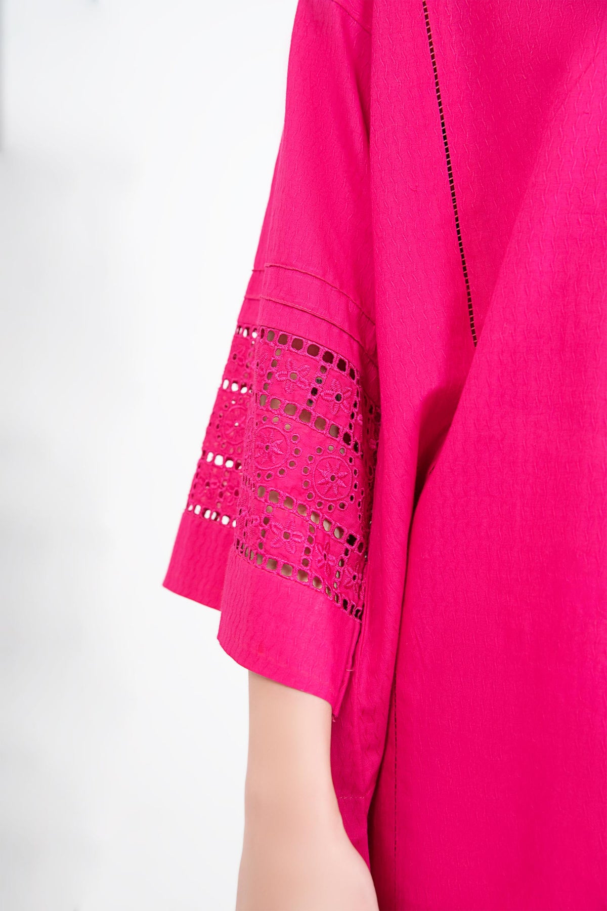 Women's bright pink two-piece tunic suit with lace-trimmed sleeves and matching trousers