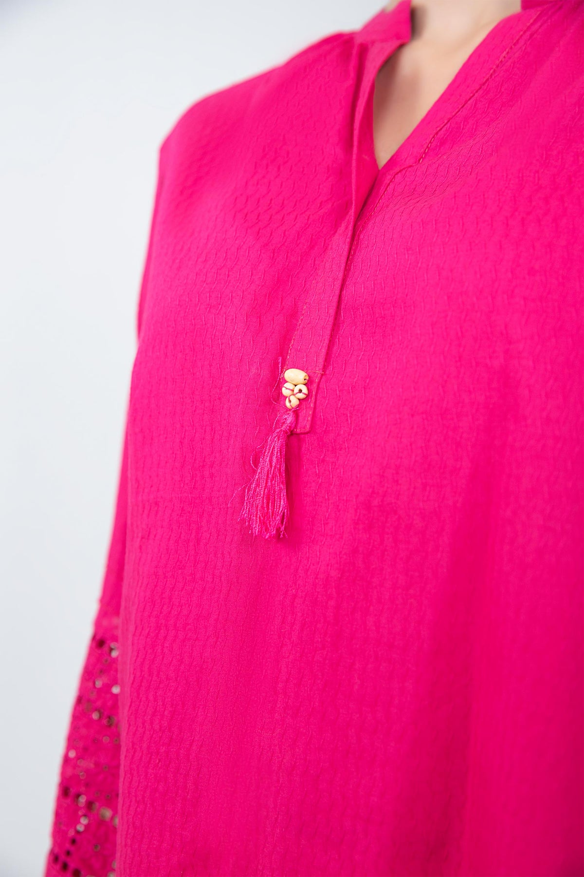 Women's bright pink two-piece tunic suit with lace-trimmed sleeves and matching trousers