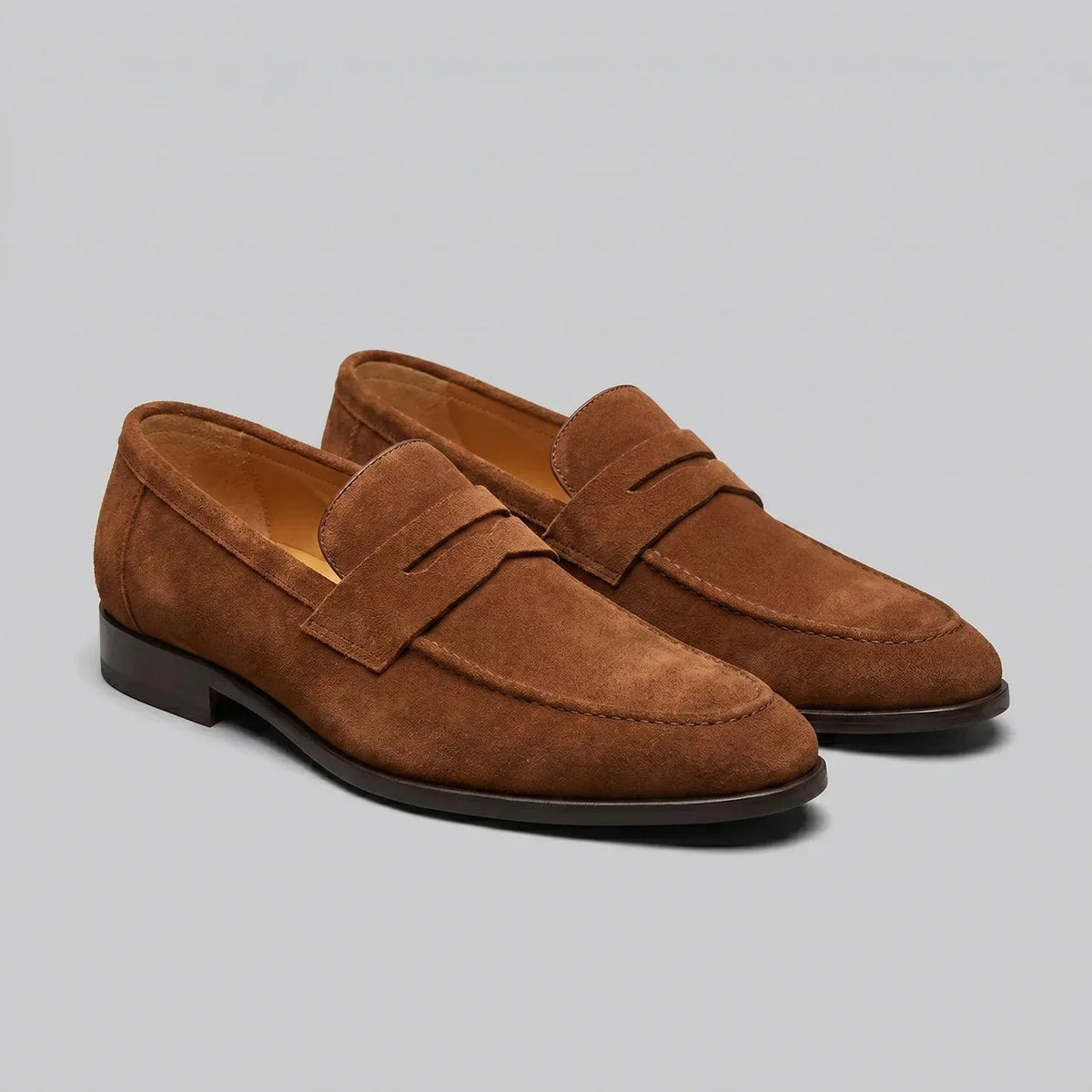 Men's penny loafers with closed backs, raised vamp straps and low flat heels