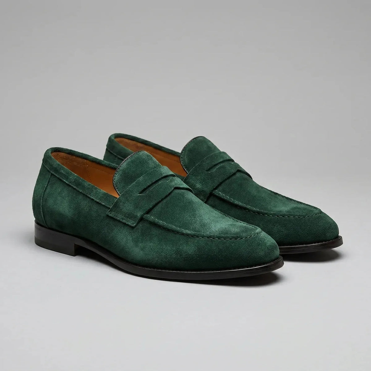 Men's penny loafers with closed backs, raised vamp straps and low flat heels
