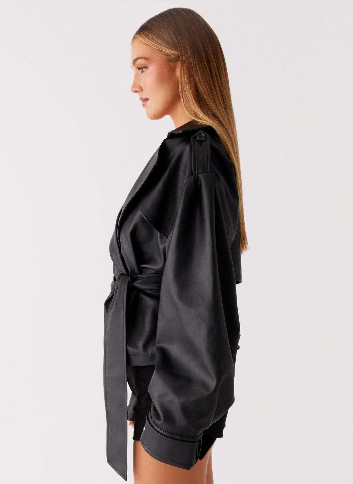Women's black belted trench jacket with wide lapels and long sleeves