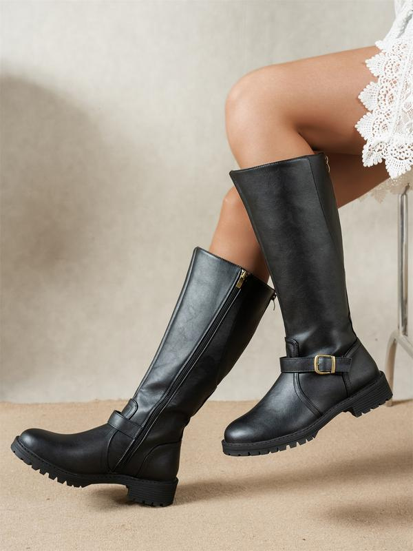 Women's knee-high riding boots with side zips, buckle straps and lugged soles