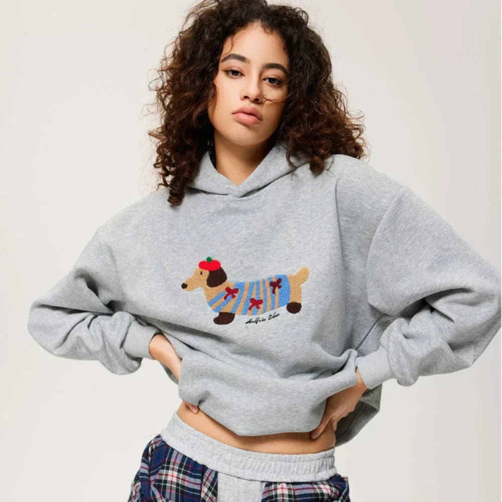 Women's hooded sweatshirt with embroidered dog graphic, long sleeves and kangaroo pocket