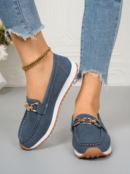Women's flat loafers with metallic buckle trim and textured lug soles